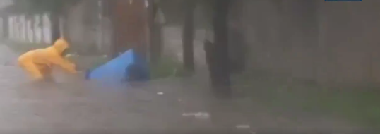 Outrage as video surfaces of Ghanaian dumping trash on flooded street amid heavy rain