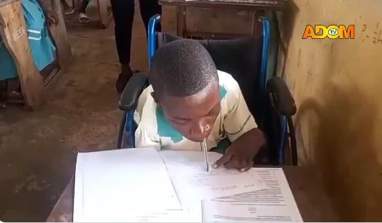 (Video) BECE: Physically challenged student uses mouth to hold pen to write exams